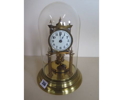 An anniversary brass clock, under a glass dome, 29cm tall 