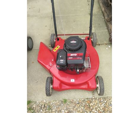 A petrol lawn mower with a Briggs and Stratton engine, rough cutter, in working order 