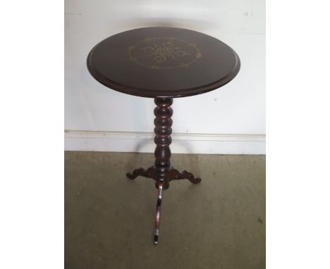 A Victorian rosewood circular top lamp table with brass and enamel marquetry insets to the top, supported on a bobbin stem, 7