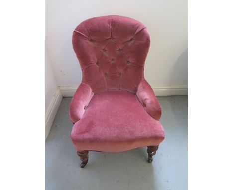A Victorian button back fireside chair, 78cm tall 