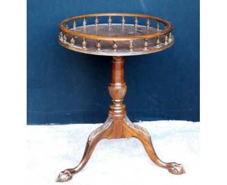 Reproduction spindle gallery mahogany tripod table raised on cabriole supports, 62cm high and 46cm diameter.