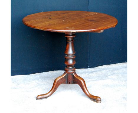 19th century circular oak tripod table with tilt top and cabriole legs, 76cm high and 92cm diameter.