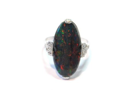 Dress ring with black opal oval doublet flanked by twelve small mixed-cut diamonds, in white gold. Condition Report Chips, si