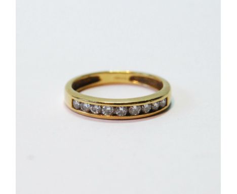 Diamond half eternity ring with channel-set brilliants, in 18ct gold, 1979. Condition Report Size K