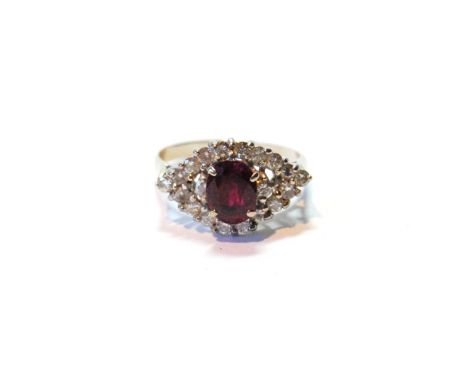 Diamond and ruby ring of navette shape with a cushion-shaped ruby flanked and surrounded by brilliants, in white gold.