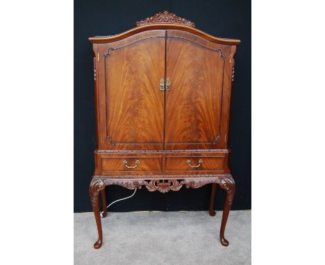 Reproduction flame mahogany cocktail cabinet in the Chippendale style, 160cm high and 98cm wide.