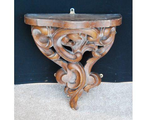 Victorian carved oak bracket of serpentine form, 57cm high, 48cm wide and 31cm deep. Condition Report Good condition, no loss