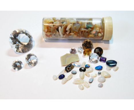 Three un-mounted cut quartz, a quantity of opal fragments and un-mounted gems.