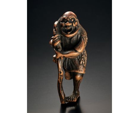 Netsuke. Tekkai Sennin im Blättergewand mit Stab. Ungedeutete Signatur. Kleine Fehlstelle am Fuß. Buchsbaum. 18./19. Jh. H 5 