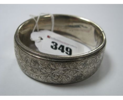 A Wide Hallmarked Silver Bangle, with part foliate design.