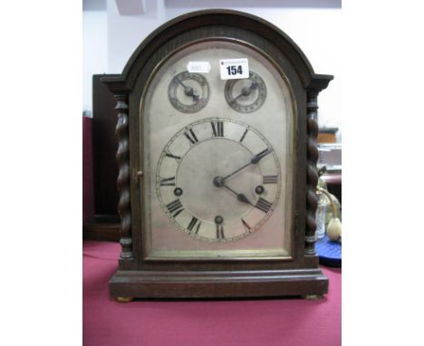 A 1920's Oak Dome Cased Bracket Clock, with barley twist pillars, Westminster chime movement slow/fast, silent chime dials to