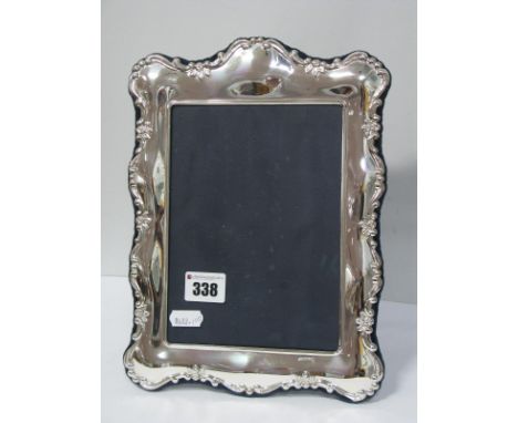 A Modern Hallmarked Silver Mounted Rectangular Photograph Frame, of shaped design, on plush blue easel back, overall height 2