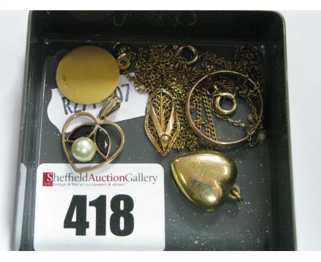 A Circular Pendant of Religious Design, stamped "750", on fine chain, a 9ct gold plain heart shape pendant, another heart pen