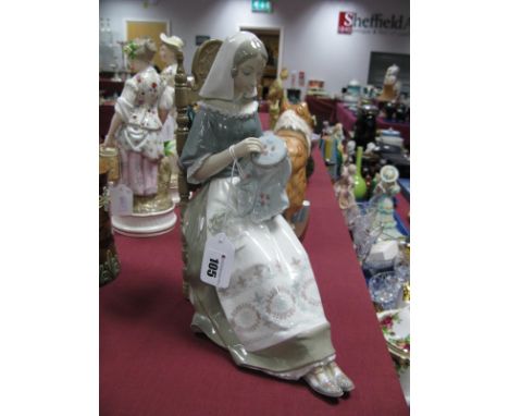 Lladro Figure 'Embroidery Lady', a seated lady with tapestry.