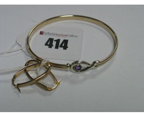 A Modern 9ct Gold Bangle, circular collet set to the front; a pair of elongated hoop earrings, stamped "375".