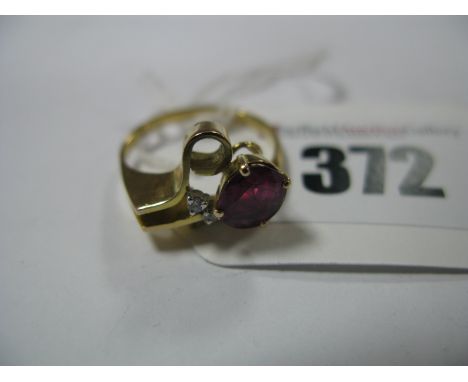 A Ruby and Diamond Set Cocktail Dress Ring, of abstract design, oval four claw set within stylised setting, stamped "585".