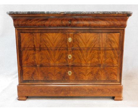 A 19th century French Louis Philippe figured mahogany commode chest with a white flecked grey marble top with shaped frieze d