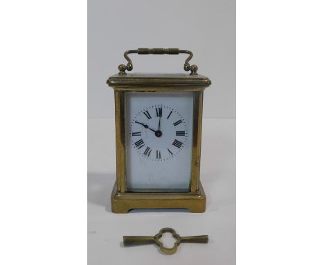 A French antique brass carriage clock with white enamel dial and black Roman numerals. Movement stamped made in France. H.15 