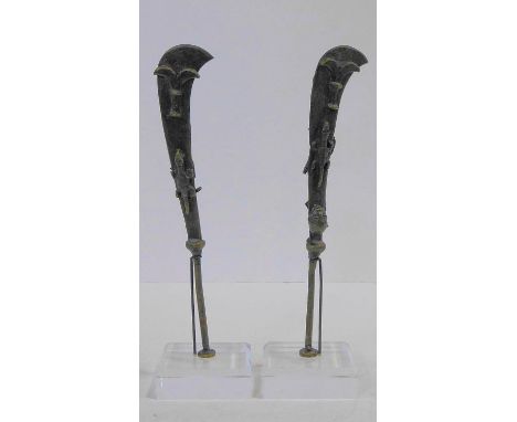 A pair of miniature Ahanti bronze swords with sculpted fish and scorpion motifs. Mounted on perspex and metal display stands.