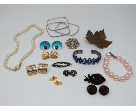 A collection of vintage jewellery. Including a pair of enamel gold plated geometric earrings, a pair of Givenchy gold tone st