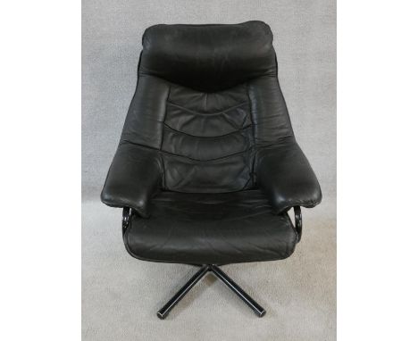 A vintage black leather upholstered reclining armchair with swivel action on metal five point base. H.94cm 