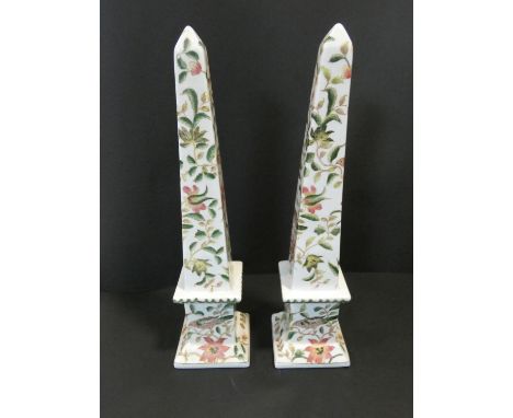 A pair of Chinese ceramic obelisks with all over bird and flower decoration and Chinese character marks to the base. H.42cm 