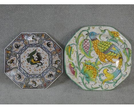Two large octagonal hand painted ceramic Majolica chargers. One with a stylised bird among flowers, signed by artist, the oth