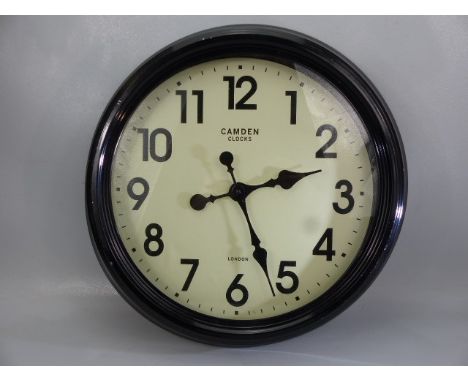 Black metal wall clock marked Camden Clocks London, approx. 47 cm wide