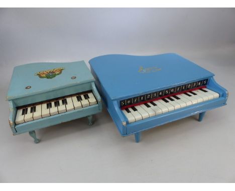 Two vintage baby grand piano toys.