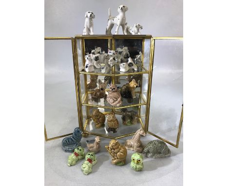 Collection of ceramic animals in a three tier metal display case (height 75cm)