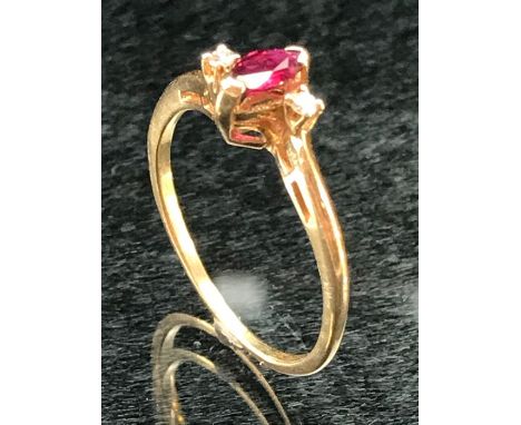 9ct Gold ladies ring with central oval Ruby and flanked by two Diamonds.size N