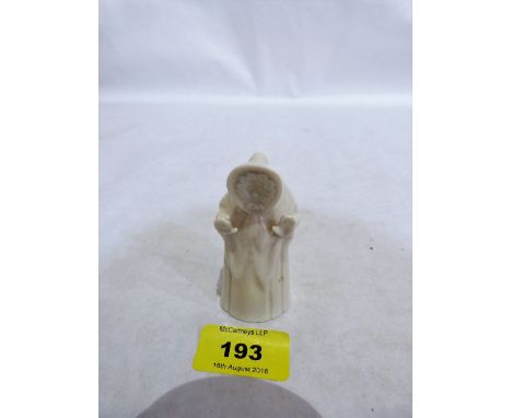 A Royal Worcester candle snuffer, Welsh lady, in white glaze. Unmarked
