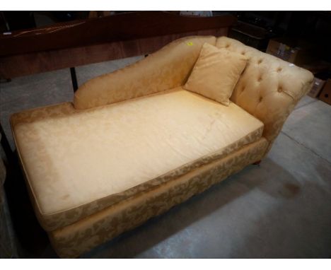 A chaise-longue sofa bed upholstered in gold brocade