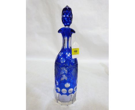 A 19th century blue overlaid wine decanter with wheel engraved decoration of vine fruits. 13½'' high