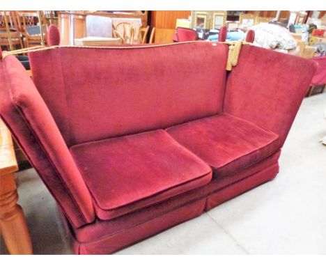 A Knole sofa upholstered in red dralon