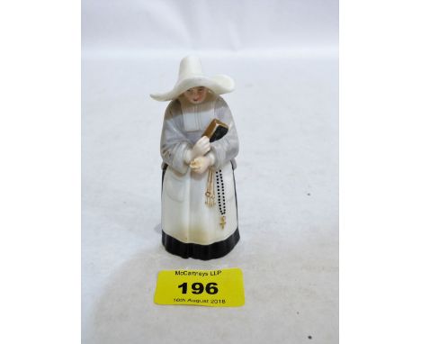 A Royal Worcester candle snuffer, nun with bible and rosary. 1892