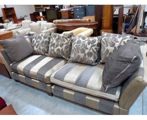 A Duresta drop-end sofa upholstered in brown and fawn fabric with scatter cushions. 100'' wide