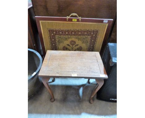 A firescreen with textile banner and an oak occasional table