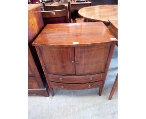 A George III mahogany and line inlaid bow-breakfronted commode cupboard enclosed by a pair of doors over two drawers on squar