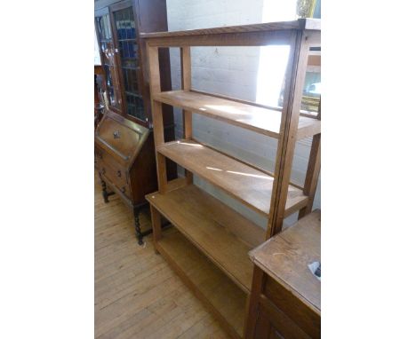 A decorative light oak open fronted freestanding shelving unit.