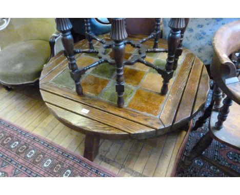 A mid 20th Century oak and tile topped coffee table of circular form