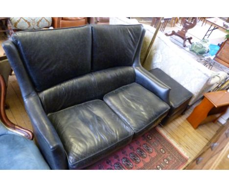 An excellent quality black leather two seater wingback black leather sofa, complete with matching pouffe, each having brass s