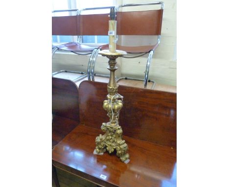 A large gilt wood table lamp in an ornate style.