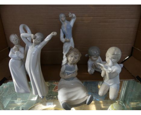 A collection of Nao and similar ornaments to include a range of various models of children, a model of a swan and others (7)