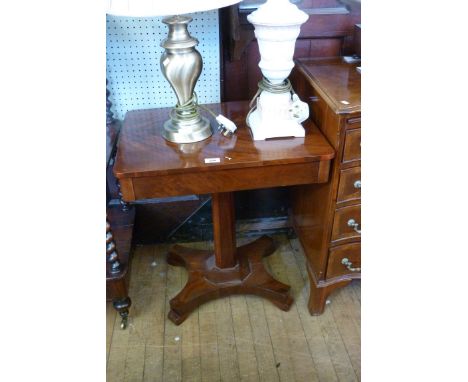 A 19th Century flame mahogany lamp table, the rectangular top raised on chamfered block supports, height 63cm, length 58cm.