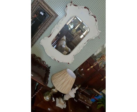 A reproduction shabby chic white painted wall mirror, together with a similar table lamp in the form of a Grecian urn (sold e