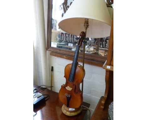 A contemporary decorative table lamp, modelled in the form of a violin with a metal column lamp (sold electrically untested) 