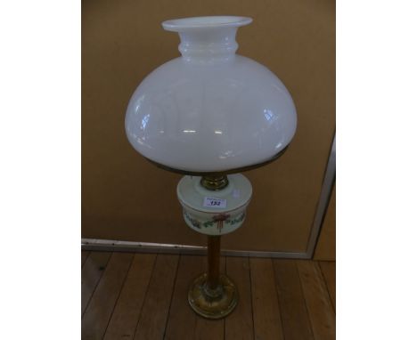 A small late 19th/early 20th Century oil lamp, with brass base, opaque font and opaque glass vesta shade.