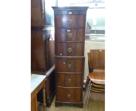 A Victorian flame mahogany tall and narrow bowfront chest on chest, having six drawers, each with brass Prince of Wales feath