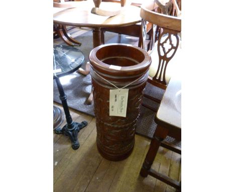 A reproduction carved hardwood stick stand, of cylindrical form.